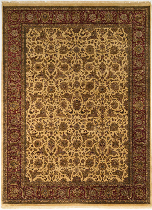 An ornate traditional area rug with a central field of beige and brown floral motifs, surrounded by a dark red and green patterned border.