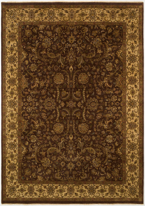 A traditional oriental-style area rug with an intricate floral and scroll pattern in dark brown and beige tones, shown flat from above.