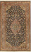 An ornate rectangular Persian-style rug with a dark navy and black field, cream floral motifs, and a detailed border in beige, gold, and muted green, finished with white fringe on the top and bottom.