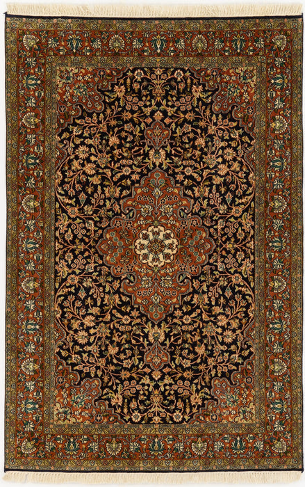 An oriental-style area rug with an intricate floral pattern, featuring a dark central field, a warm rust-red border, and cream fringe on the top and bottom.