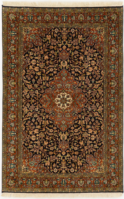 An oriental-style area rug with an intricate floral pattern, featuring a dark central field, a warm rust-red border, and cream fringe on the top and bottom.